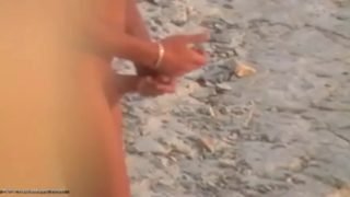 A person wanking on the seashore